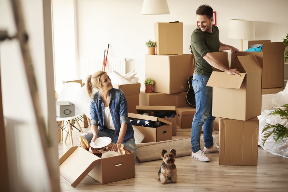 Couple packing up when while moving in a new home.